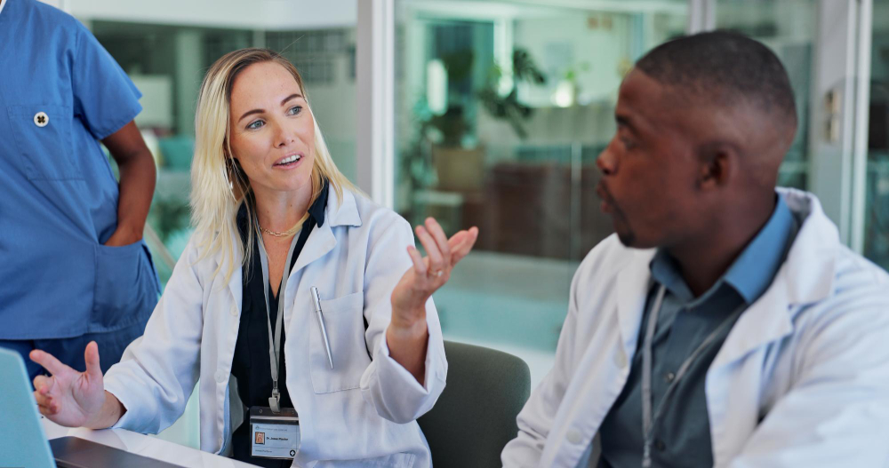 a female and male wound care doctor discussing chronic wounds at a table